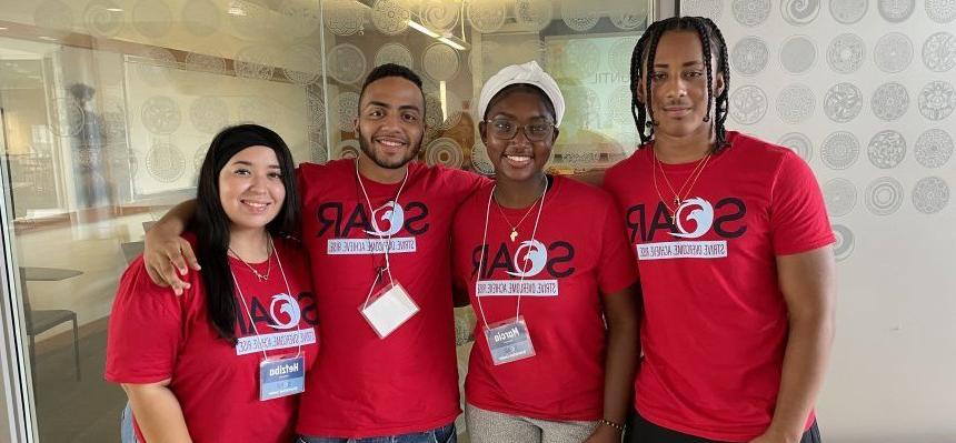 A group of students wearing S.O.A.R. t-shirts